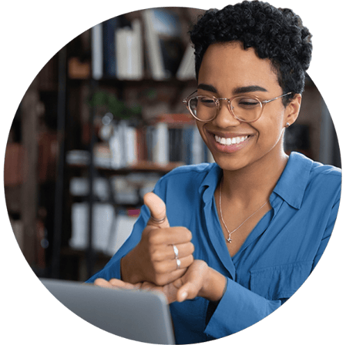 Young woman smiling while working at a computer.