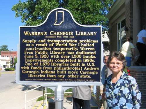 Rosalie Walter, the marker applicant, with the historical marker.