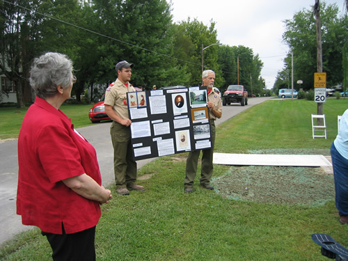 Members of Osgood Scout Troop 638, who presented the Colors for the dedication ceremony, are seen here holding an exhibit board for Diane Perrine Coon’s presentation.