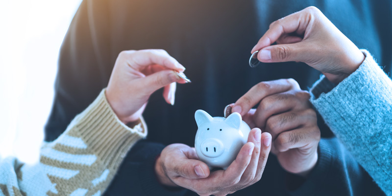 people putting money in a piggy bank