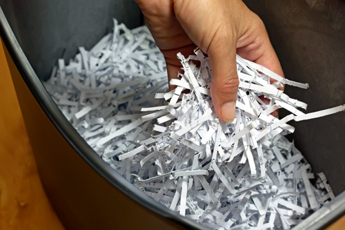 Hand holding shredded paper