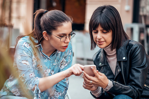 Friends talking about what is on phone