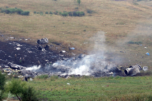 Airplane crash in field with debris