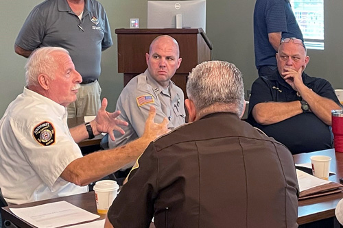 Man speaking at table discussion