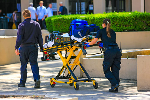 EMS paramedics walking with a gurney