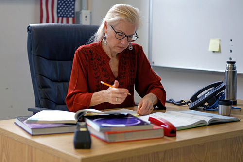 Teacher at desk working on lesson plans