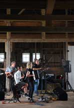 Scott Greeson and Vickie Maris perform inside the barn at The Farm at Prophetstown State Park with band members Greg Brassie on bass and Mark Boyd on mandolin. (Brent Drinkut photos)