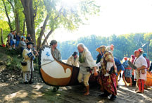 
Members of the Ouiatenon Brigade bring their canoe ashore from the Wabash. Formed in 1973, the brigade participates in the Feast every year, portraying the lives of French voyageurs. Brent Drinkut photo.
  