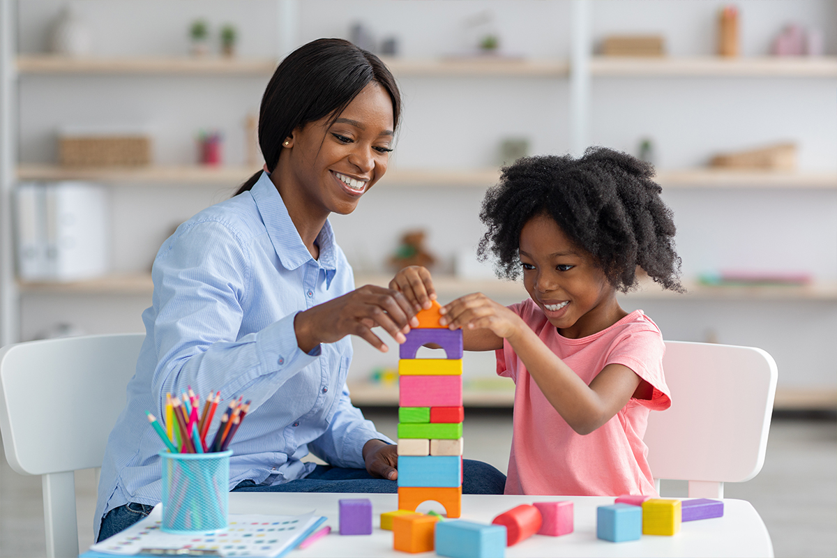 Woman and child stacking blocks