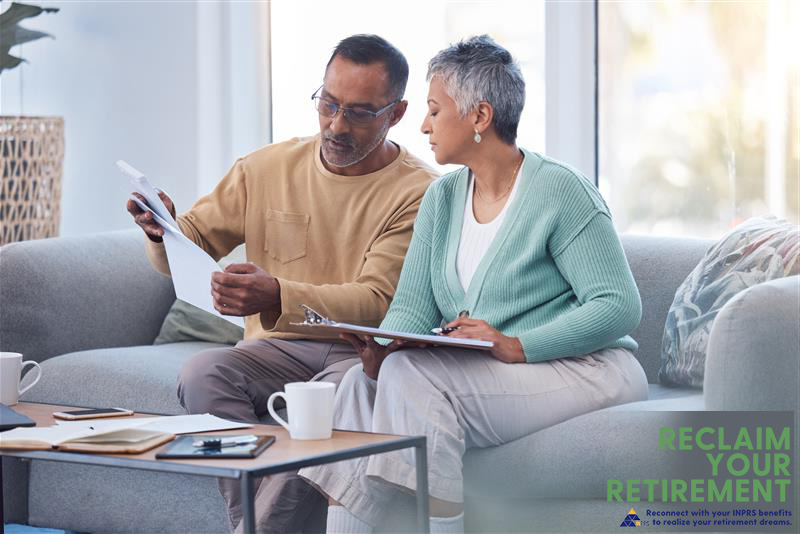 A couple on the couch doing financial planning.